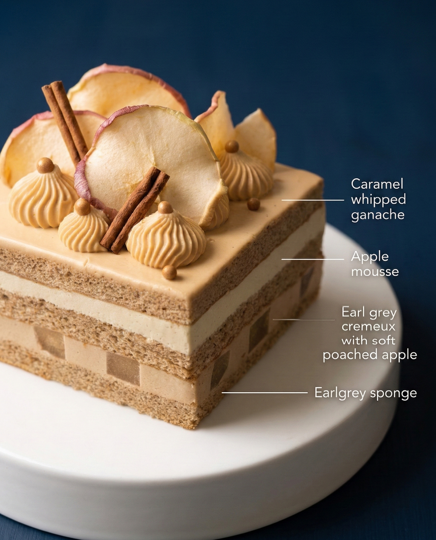 Cross-section of an elegant layer cake showing Earl Grey sponge, vanilla-poached apples, and caramel whipped ganache.