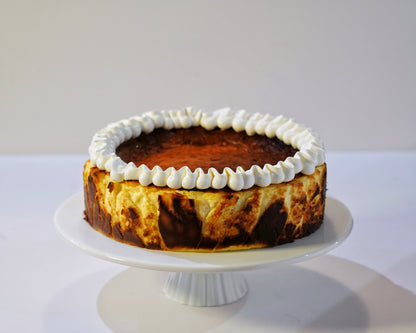 Cross-section of a Classic Basque Cheesecake showing its rich, smooth, and molten oozy vanilla centre.