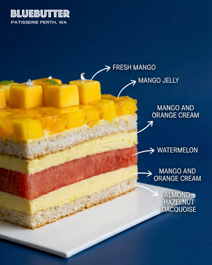 Cross-section showing a fresh slice of watermelon, juicy seasonal mangoes, and orange cream on an almond and hazelnut biscuit base.