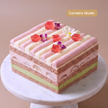 Close up of a premium Lychee and Pandan Layer Cake topped with house-made rose jelly and edible petals, created by BLUEBUTTER Patisserie in Perth.