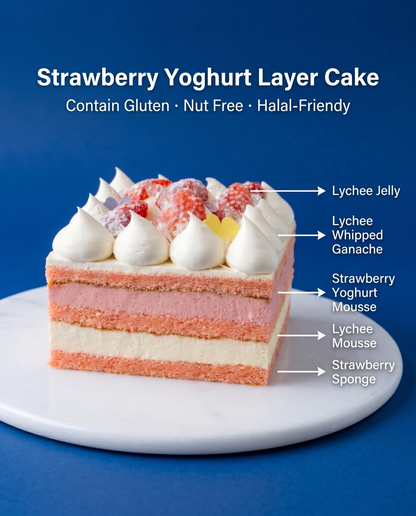 A slice of Strawberry Yoghurt Lychee cake showing delicate pink sponge layers and smooth mousse on a glass cake stand.