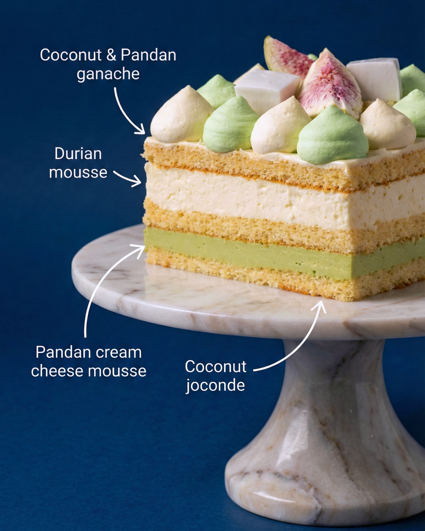 Cross-section showing a generous 200g D24 durian puree heart, pandan cream cheese mousse, and a tender coconut joconde base.